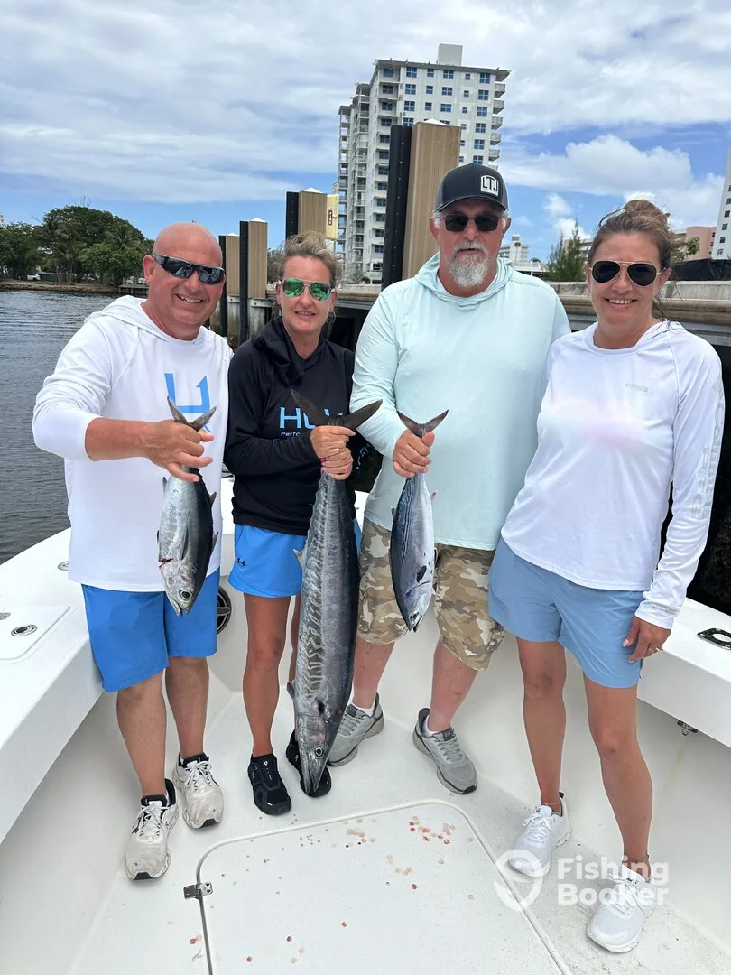 A group of anglers at the dock with their wahoo