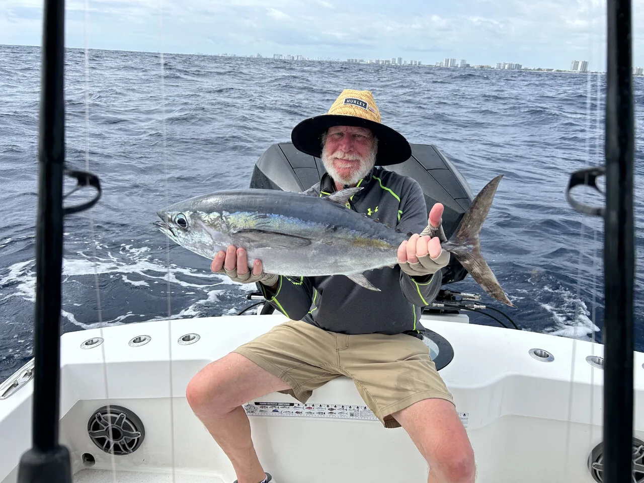 Angler holding a kingfish caught on a half day charter out of Pompano Beach