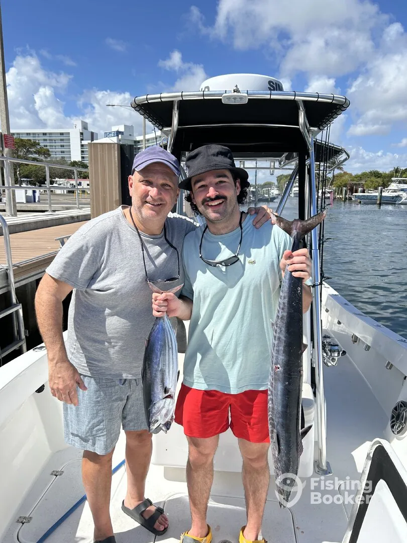 Two anglers with a wahoo at the NE 14th Street Causeway dock